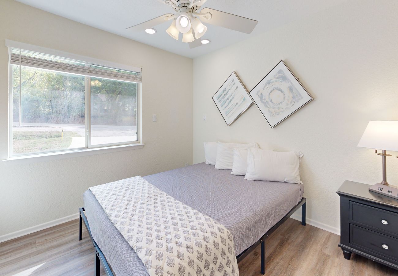 Queen bedroom with window view of River Road