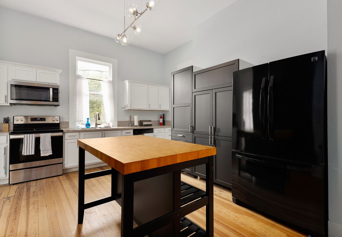 historic home perfect for couples vacation kitchen w tall ceilings, white shaker cabinets, stainless appliances