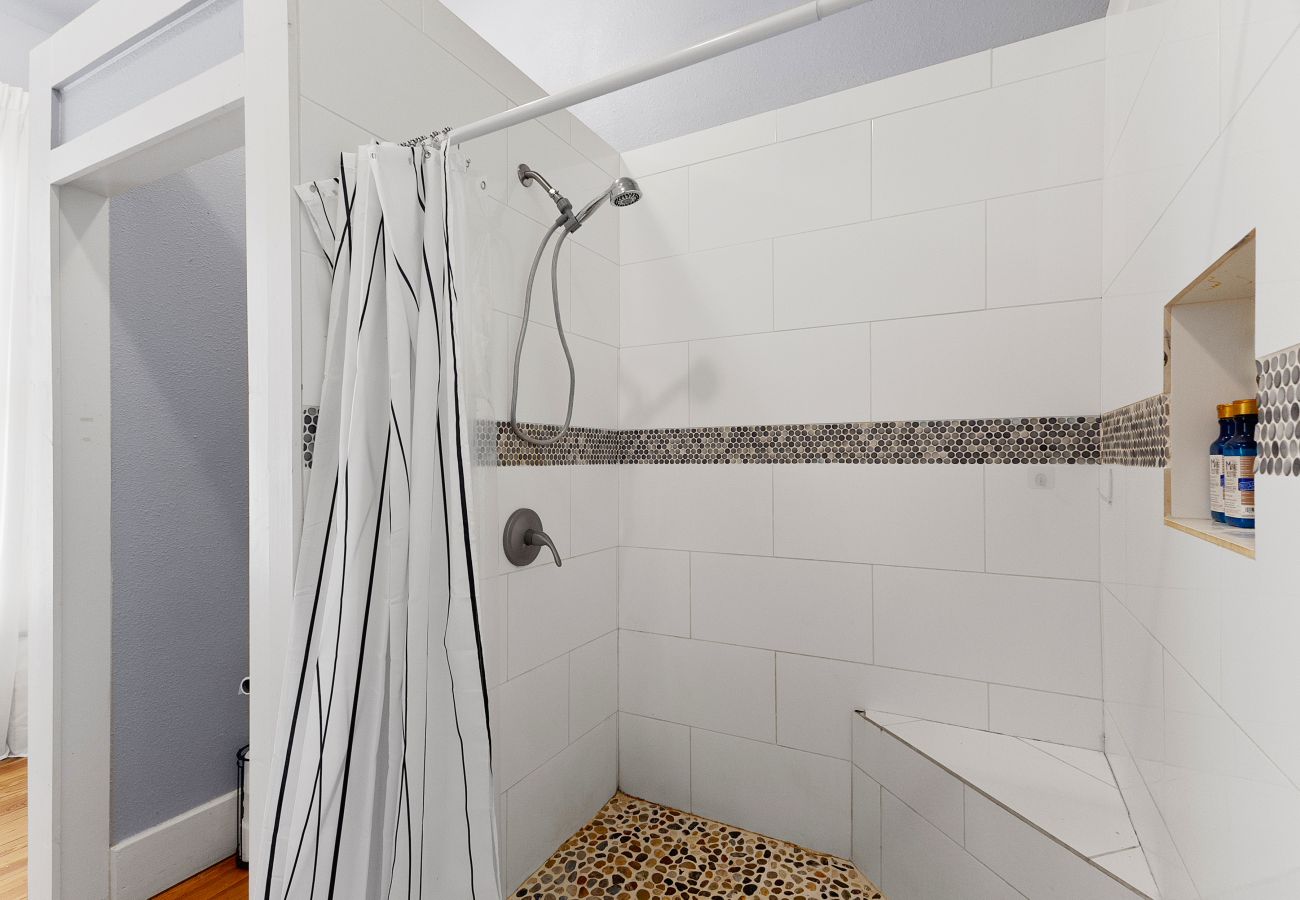 primary bathroom, white subway tile, brass sconces, globe lights Master bathroom with clean lines fluffy towels & personal touch