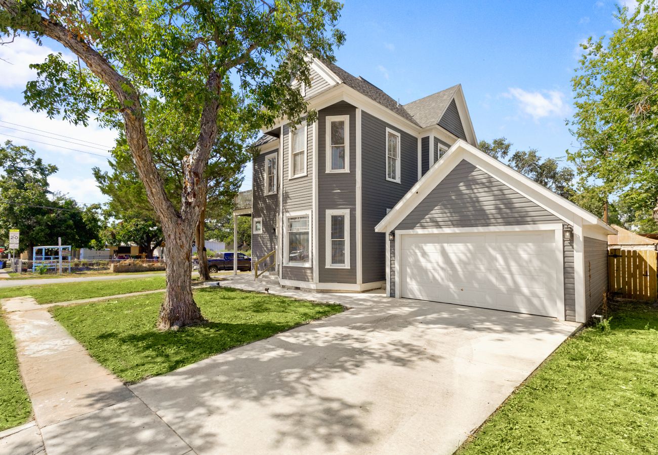 Front exterior of The Bowie Grand, a historic 4-bedroom vacation rental in downtown Seguin  and private driveway.